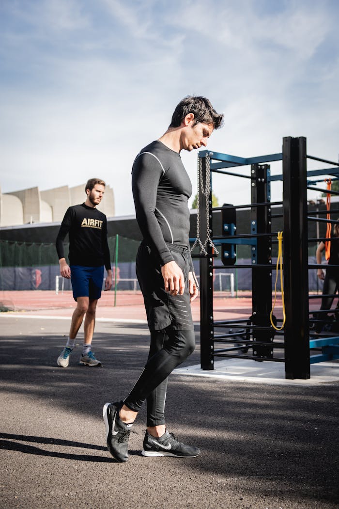 Two men working out in an outdoor urban gym in Boulogne-Billancourt, France.